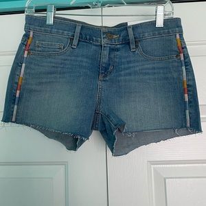 Denim cutoffs with rainbow side stitching